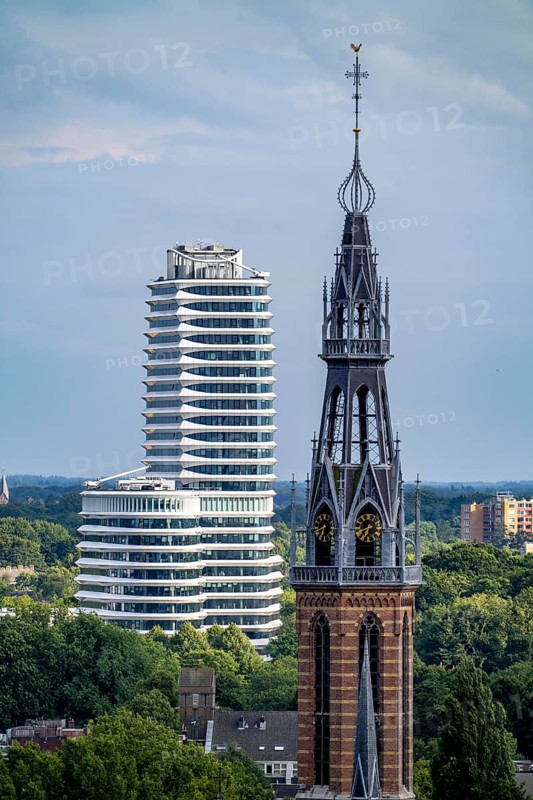 St Joseph's Cathedral Sint Martinusparochie Groningen in the foreground, behind it the tax office building of Groningen, Belastingkantoor, with 2300 workplaces and 25 floors, also here is the Dutch Student Loans Office, Netherlands