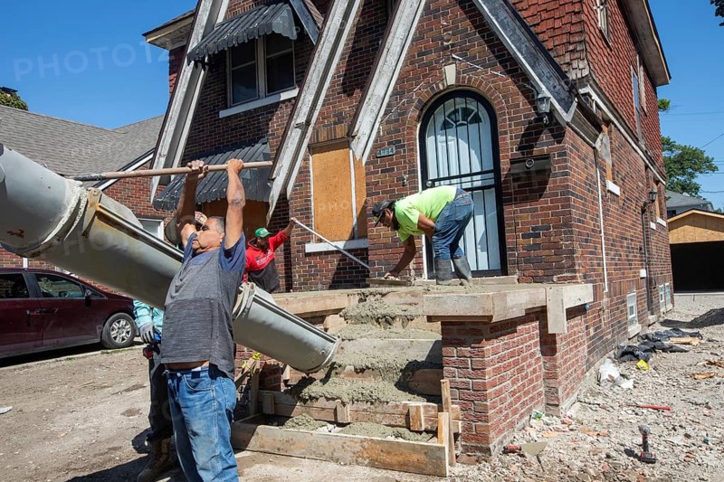 Detroit, Michigan, Workers rebuild front porch of a house they are remodeling in the Morningside neighborhood. The house had been vacant for many years. Detroit lost nearly two-thirds of its residents from 1950 to 2020 but has been growing modestly in recent years