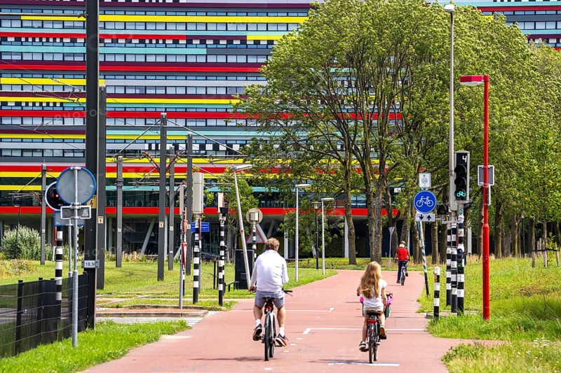 Cycle path through the university campus in Utrecht Science Park, Utrecht University, colourful facade of the Hogeschool Utrecht building, Netherlands