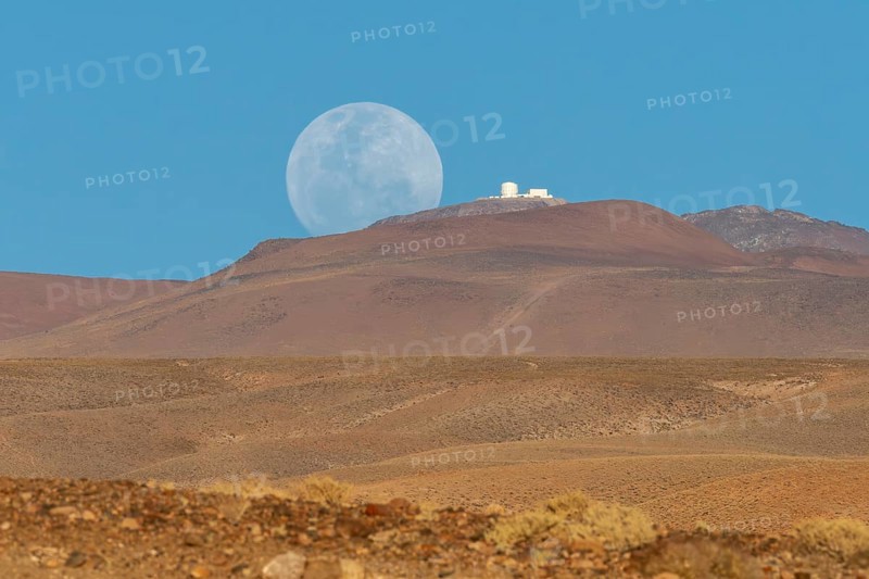 An observatory on a mountain next to the rising full moon, San Pedro de Atacama, San Pedro de Atacama, Región de Antofagasta, Chile