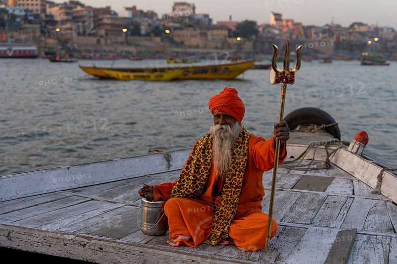 Sadhu with trident on boat, Katesar, Mughalsarai, Uttar Pradesh, India