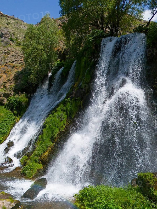 Natural waterfall under a blue sky with lots of greenery, aerial view, Shaki waterfall, Shaki, Syunik province, Armenia