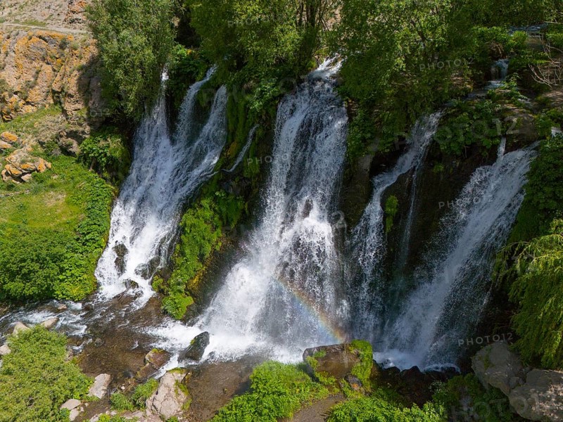 Waterfalls with lush greenery and rainbow in the sunlight, aerial view, Shaki waterfall, Shaki, Syunik province, Armenia