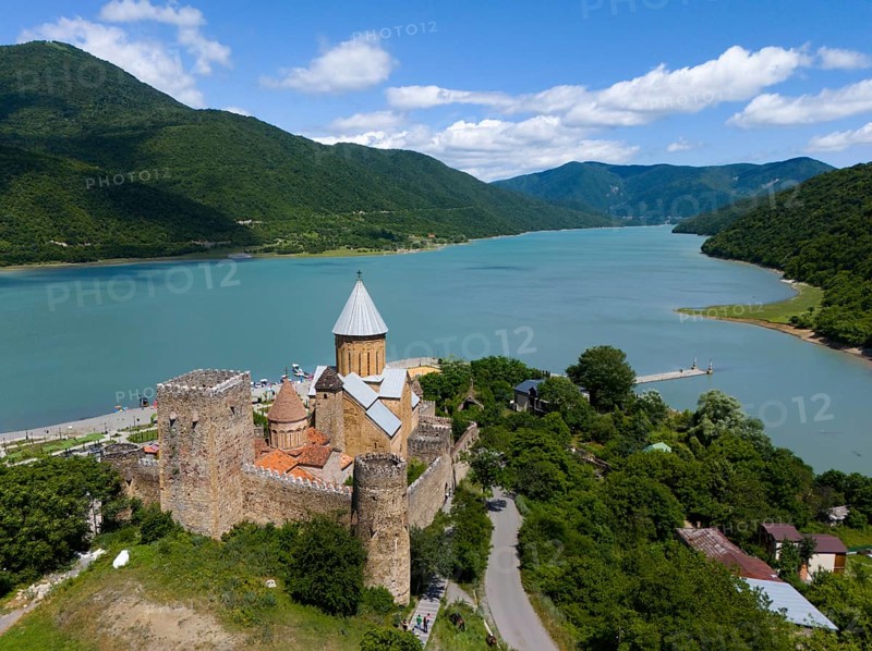 Medieval castle on the river surrounded by green mountains under a cloudy sky, aerial view, Ananuri castle, Zhinvali reservoir, Shinvali, Jinvali or Shinvali, Mtskheta-Mtianeti region, Georgian Military Road, Georgia