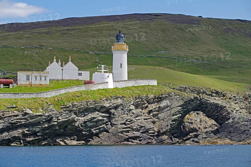 Lighthouse and building on green coastal landscape above the sea, Stevenson family, Noss, Shetland Islands, Scotland, Great Britain
