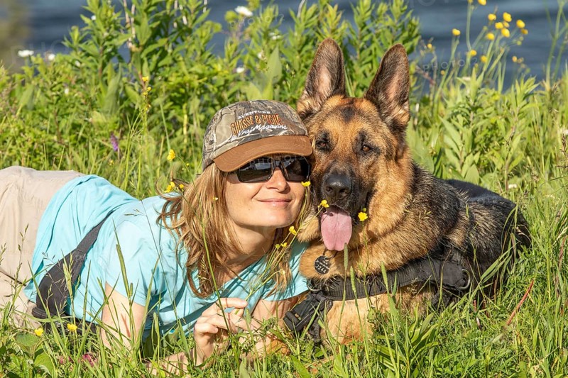 Woman and her German Shepherd lying in the grass, Woman and her German Shepherd lying in the grass, Sunny day, Gaspesie Region, Province of Quebec, Canada, North AmericaGaspesie Region, Province of Quebec, Canada, North America