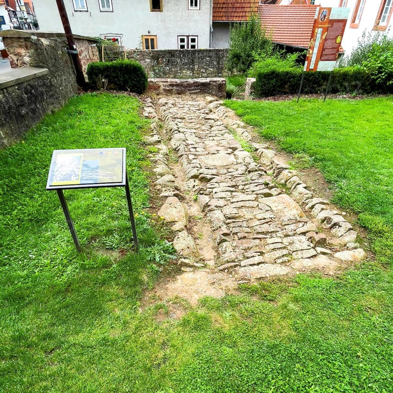 Archaeological find of original small section with old stones from historic trade route between Frankfurt am Main and Leipzig, Steinau an der Straße, Hesse, Germany, relocated to secure protected site in Steinau an der Straße