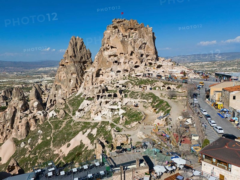 Historical rock formation with caves and buildings under a clear blue sky in a vast landscape, aerial view, Uchisar Castle, Uçhisar Kalesi, impressive rock formation and fortress, Göreme National Park, Göreme Tarihî Millî, Nevsehir Province, Nevsehir, Cappadocia, Cappadocia, Kapadokya, Cappadocia, Central Anatolia, Turkey