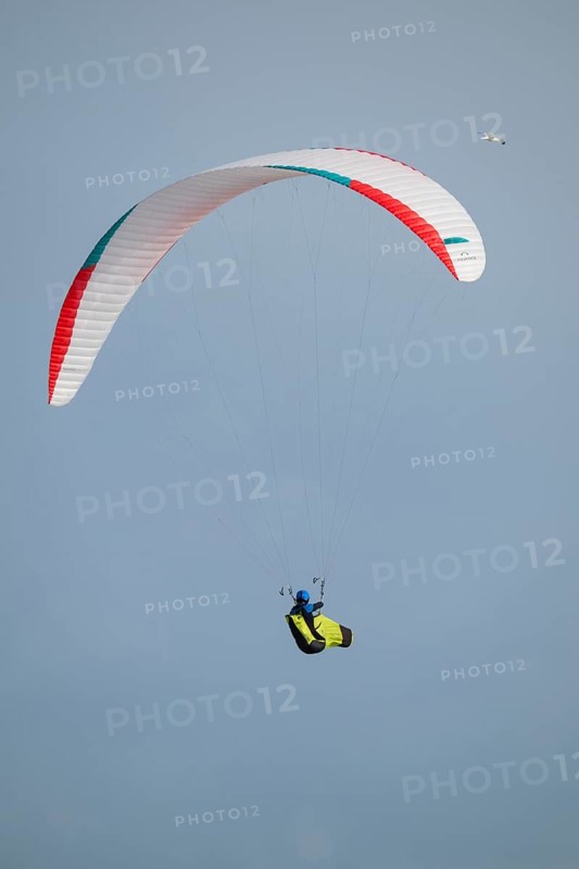 A paraglider or paraglider in front of a blue sky, near Hvide Sande, North Sea, Denmark