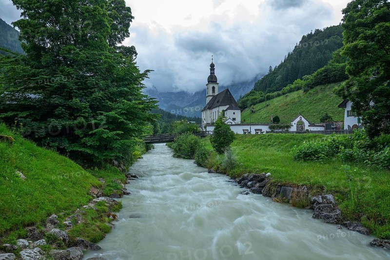 St Sebastian in Ramsau in Berchtesgadener Land with rain clouds after heavy rain