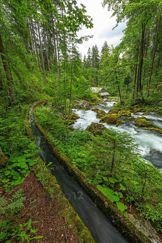 Golling watermill from above at the waterfall with the water pipe. Traditional mill in an alpine landscape, Golling an der Salzach, Austria