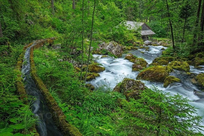 Golling watermill from above at the waterfall with the water pipe. Traditional mill in an alpine landscape, Golling an der Salzach, Austria