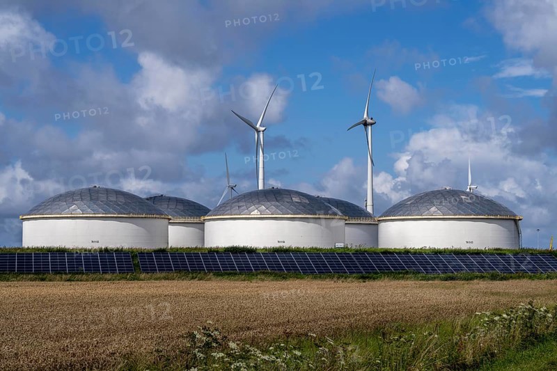 Wind turbines of a wind farm near Eemshaven, VOPAK tank farm, solar plant, Netherlands