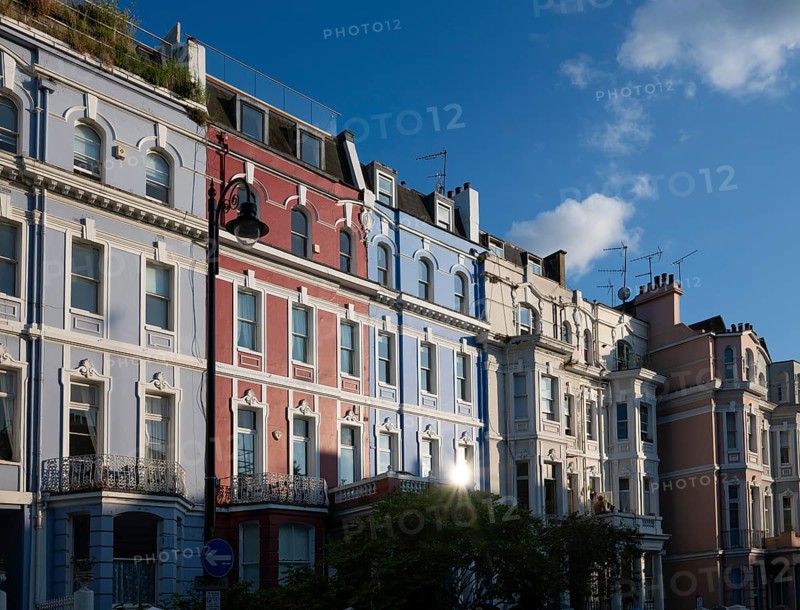 Terraced houses, townhouses with different, colourfully painted facades under a blue sky, Portobello Road, Notting Hill, London, England, Great Britain