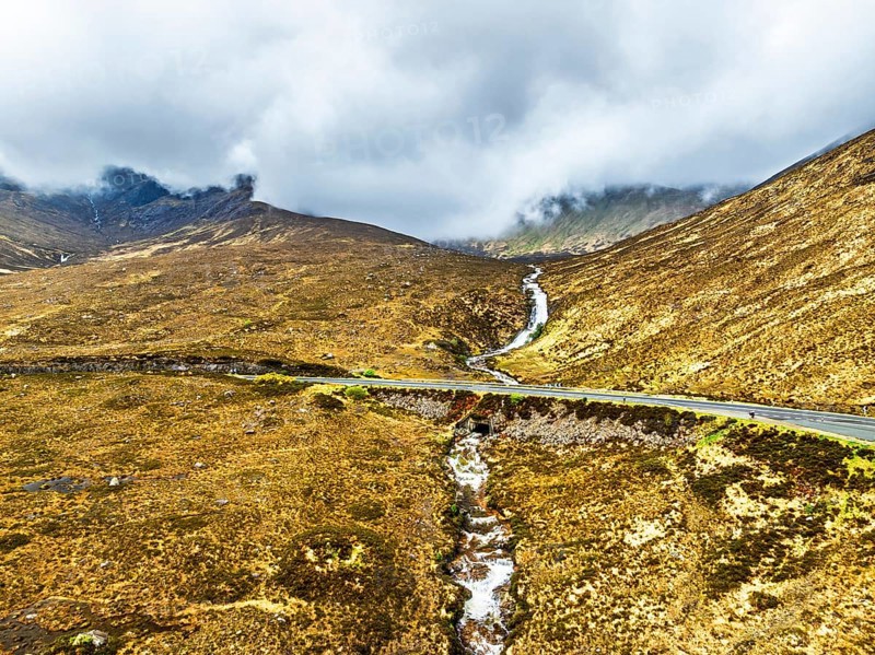 Eas a' Bhradain Waterfall from drone, Red Cuillin mountains, Loch Ainort, Isle of Skye, Scotland, UK