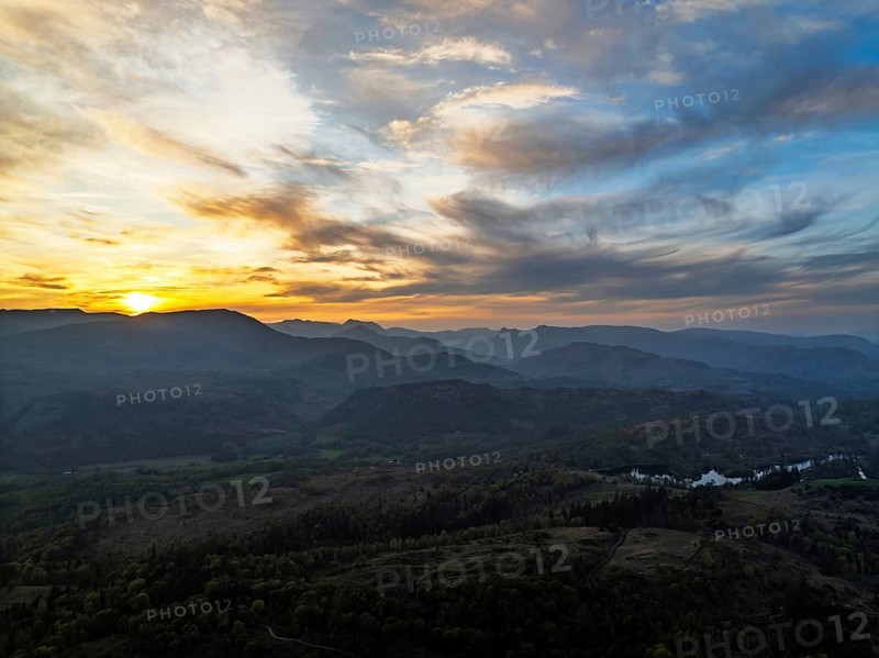 Sunset over Mountains and Coniston Water from drone, Lake District National Park, Cumbria, England, United Kingdom