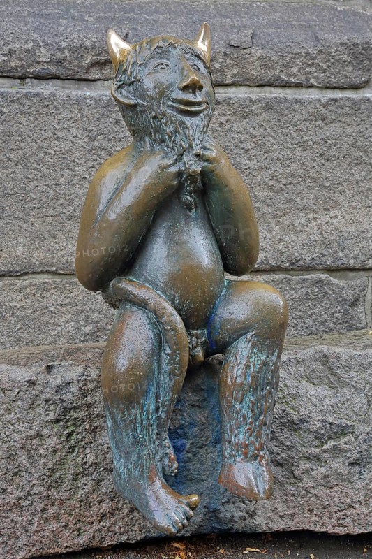 Sculpture Devil by Rolf Goerler 1999 sitting on the Devil's Stone, bronze sculpture, modern art, St. Mary's Church, Old Town, Lübeck, Schleswig-Holstein, Germany