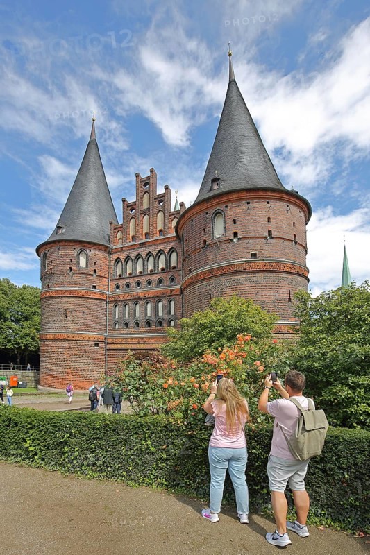 Historic Holsten Gate and tourists taking photos, Brick Gothic, Brick building, City gate, Landmark, Holsten Gate Square, Old Town, Lübeck, Schleswig-Holstein, Germany