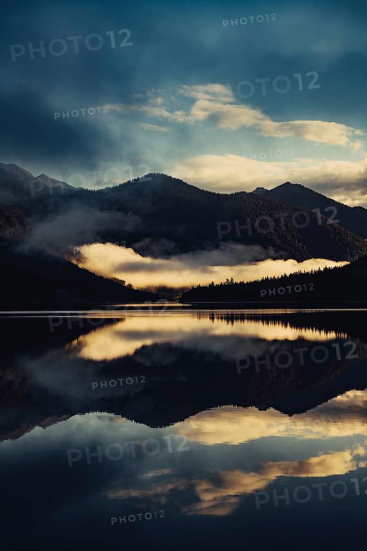 Sunrise with reflections in the Plansee in Tyrol in the Alps in Austria