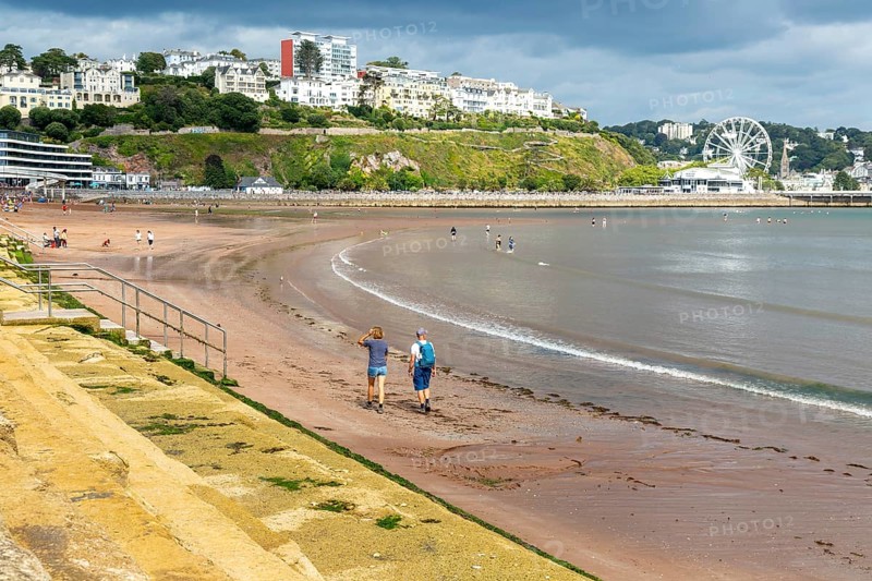 People walking on Torre Abbey Sands sandy beach, Torquay, Devon, England, UK