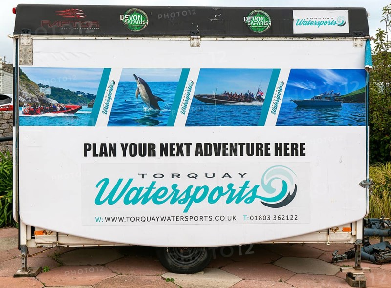 Watersports tourism adventure activity advertised on caravan vehicle, Torquay, Devon, England, UK