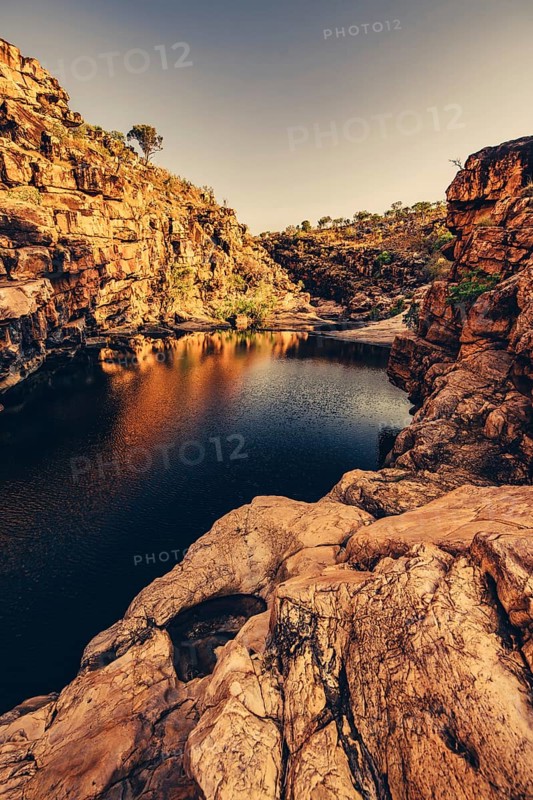 Bell Gorge waterfall, a body of water in north-west Australia in the Kimberley. Sunrise in the outback, Australia