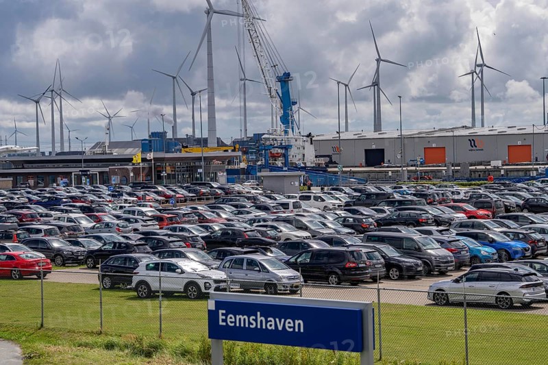 Car park at the ferry port of Eemshaven, in the Ems estuary ferry to the German North Sea island of Borkum, by AG Ems Nederland B.V., Borkumlijn, short and long-term car park, industrial port, power plants, wind farm, Netherlands