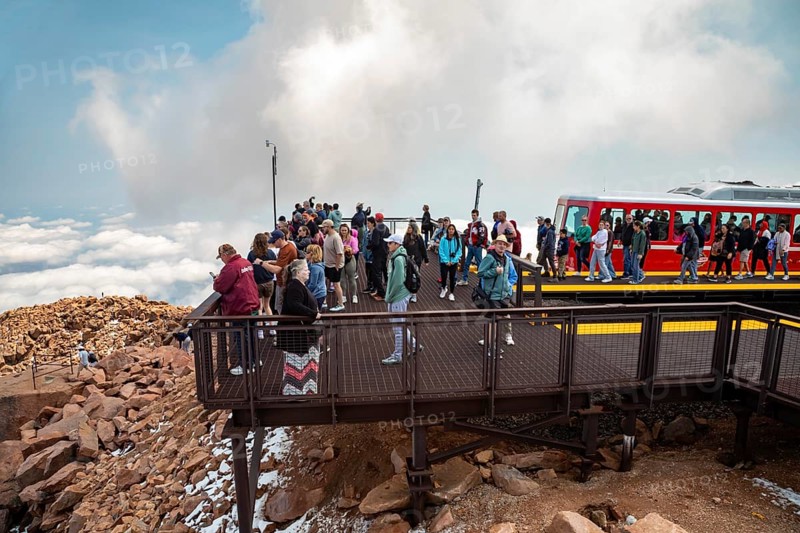 Colorado Springs, Colorado - Arriving passengers on the Manitou and Pikes Peak Railway flock to the viewing platform at the 14, 115-foot summit of Pikes Peak