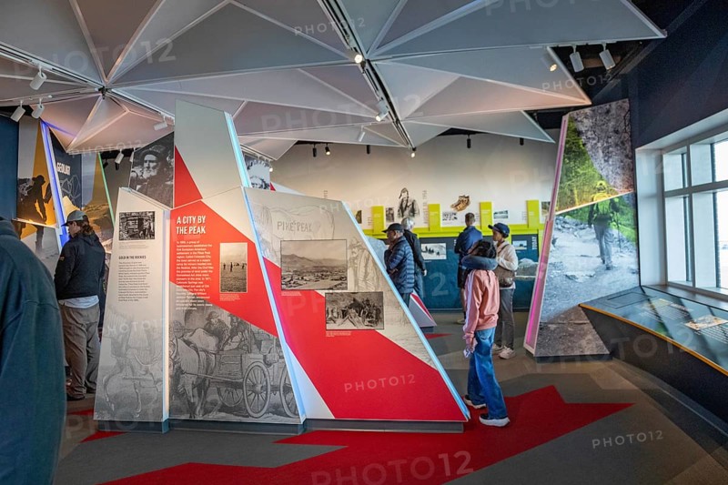Colorado Springs, Colorado - Tourists view displays in the Summit Visitor Center at Pikes Peak, a 14, 115' mountain in Colorado's front range. Thousands of tourists visit, most by driving a steep road to the summit, or riding on a cog railway