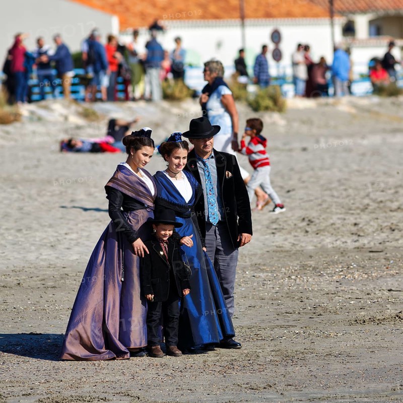 Group of pilgrims in traditional costumes, sandy beach, pilgrimage, Saintes-Maries-de-la-Mer, Camargue, France