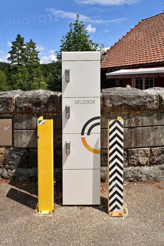 Forbach, Germany - July 12th 2025: Modern Velobox e-bike charging station with secure lockers installed in scenic outdoor location
