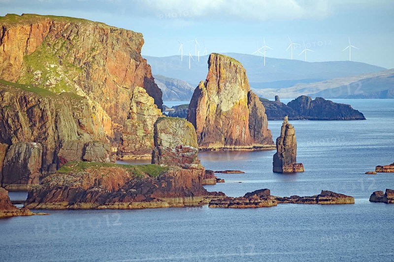 Dramatic coastal landscape with high cliffs, wind turbines and calm sea, Eshaness, Shetland Islands, Scotland, United Kingdom