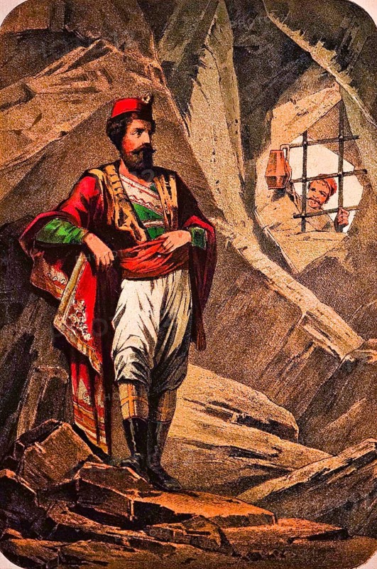 The Red Montegrin stands locked up in a rocky cave, captivity, narrative, man of high descent in valuable clothing, cloak, leather boots, proud look, bars, guard with lantern, coloured drawing, Montenegro, historical illustration 1877