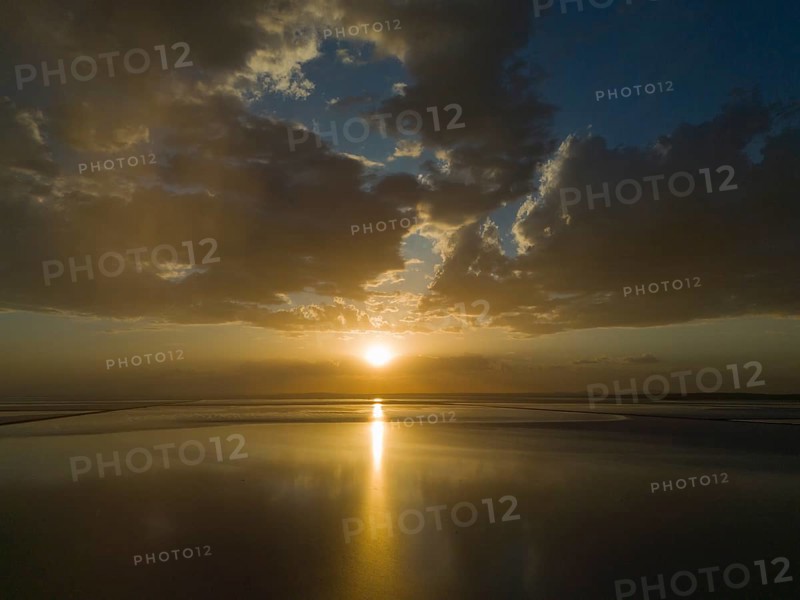 A calm sunset over a lake with golden coloured sky and clouds, aerial view, salt lake, Tuz Gölü, location between Konya, Aksaray and Ankara, Turkey