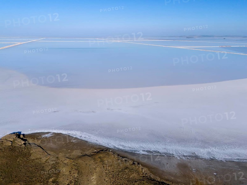 A tranquil salt landscape under a clear sky, minimalist and expansive, aerial view, salt lake, Tuz Gölü, location between Konya, Aksaray and Ankara, Turkey