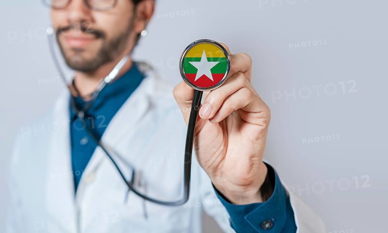 Doctor holding stethoscope with Myanmar flag. Myanmar health and care concept, Myanmar flag on stethoscope