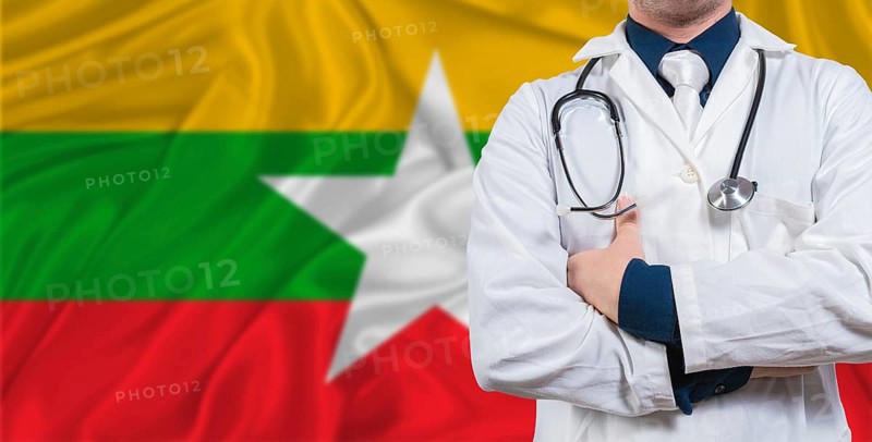 Male doctor with stethoscope on Myanmar flag. Doctor holding stethoscope on Myanmar flag