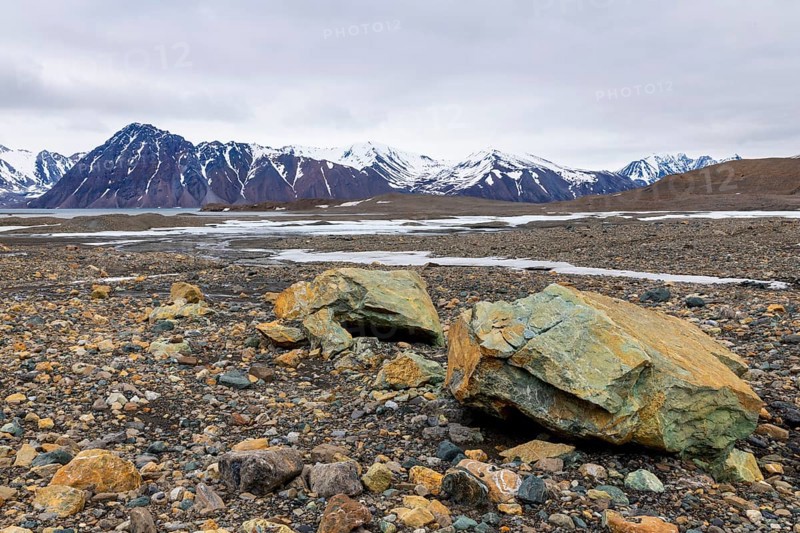 Melting glacier, copper-bearing stones, water, mountain range, Cooper Camp, Spitsbergen, Svalbard