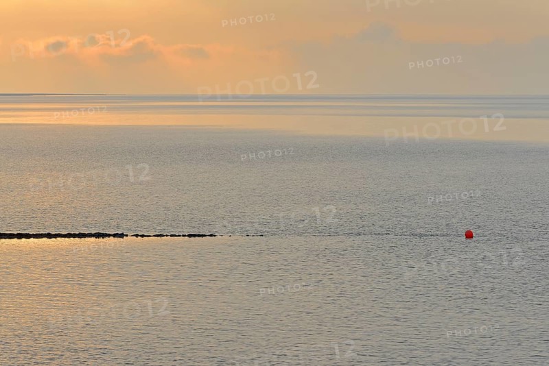 Evening mood at the Wadden Sea, stone groyne with red buoy, North Sea, Norddeich, Lower Saxony, Germany