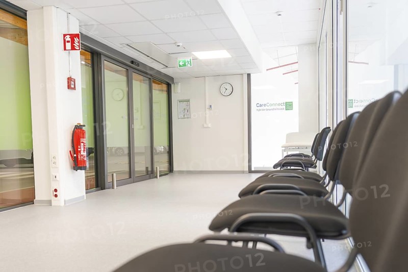 Modern corridor with chairs and escape signs in bright surroundings, Care Connect, vaccination kiosk for refugees, Calw, Germany