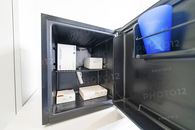 Open freezer with several medicine boxes in the office, Care Connect, vaccination kiosk for refugees, Calw, Germany
