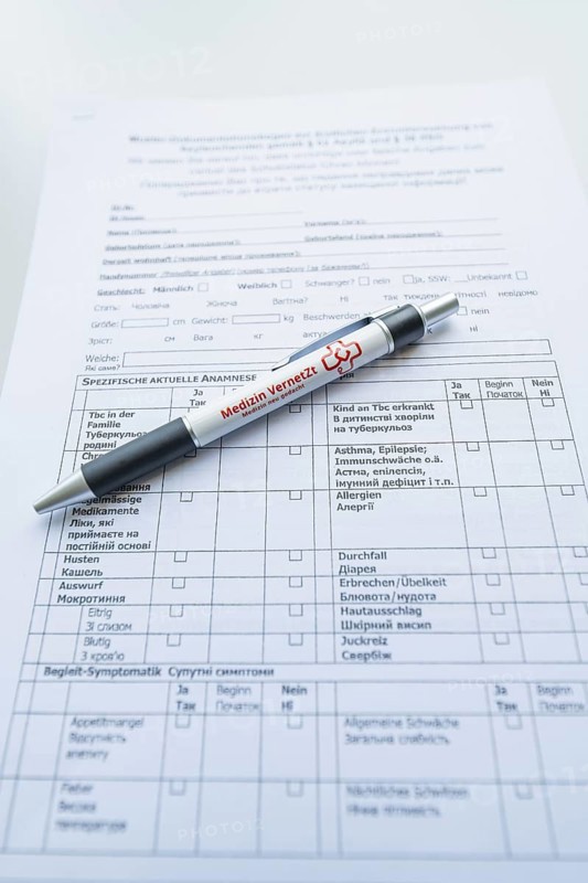 Biros on a completed form on a desk, Care Connect, vaccination kiosk for refugees, Calw, Germany