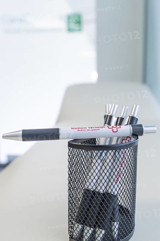Pen holder filled with pens on a desk, Care Connect, vaccination kiosk for refugees, Calw, Germany