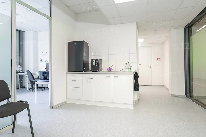 Modern kitchenette in the office with white cupboards and appliances, Care Connect, vaccination kiosk for refugees, Calw, Germany