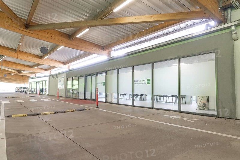 Modern building with glass front and car park at CareConnect, Care Connect, vaccination kiosk for refugees, Calw, Germany
