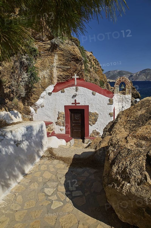 Legend, crab, shell fisherman, white chapel with red roof in rocky surroundings, paved path leading to the door, chapel, small church, Agia Kavouradena monastery, Xirokambos, Leros, Dodecanese, Greek Islands, Greece