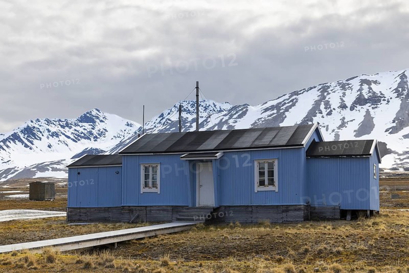 Wooden house in front of a mountain peak, Ny-Alesund, Spitsbergen, Svalbard