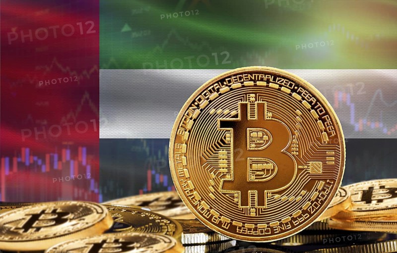 Investors in cryptocurrency and Blockchain Technology in United Arab Emirates, Concept. Bitcoin with United Arab Emirates flag in the background