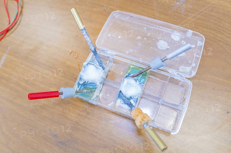 Electrical experiment with wires and a liquid in trays in the laboratory, Battery Research, Nagold, Germany