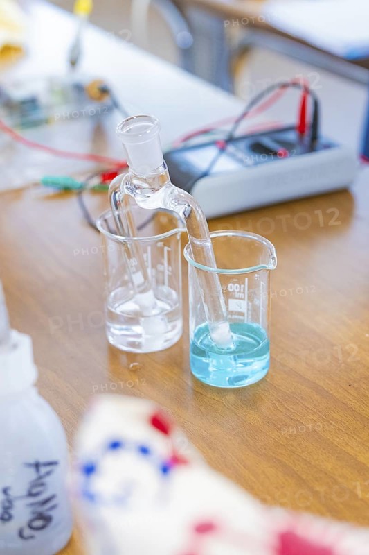 Chemical laboratory with beakers containing a clear and a blue liquid, Battery Research, Nagold, Germany
